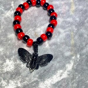 Red and blackk death head moth Kandi:00